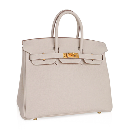 Soft Pale Concrete Neutral Gentle Pebbled Grain Compact Structured Hand Tote With Vibrant Pink Inner Lining, Brushed Golden Twist Lock Hardware And Matching Neutral Suspended Metal Padlock Charm