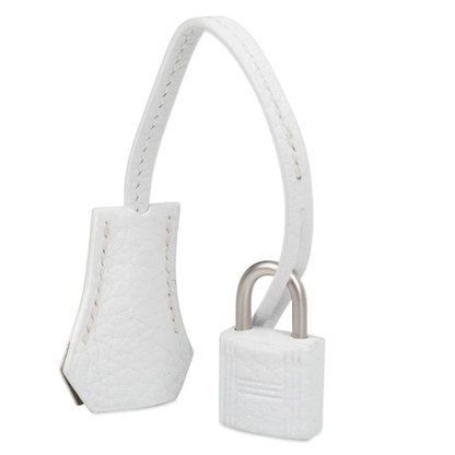 Crisp Bright White Soft Pebbled Grain Compact Box Hand Tote With Warm Muted Tan Inner Lining, Brushed Silvery Twist Lock Hardware And Matching White Suspended Metal Padlock Charm